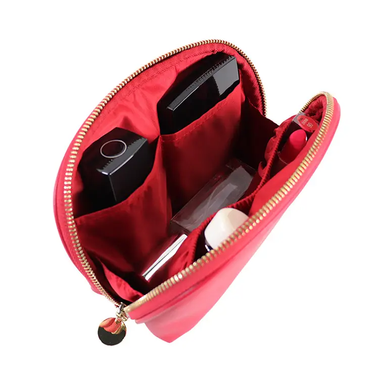 Compact travel cosmetic pouch fitting smoothly inside a luxury everyday ladies handbag